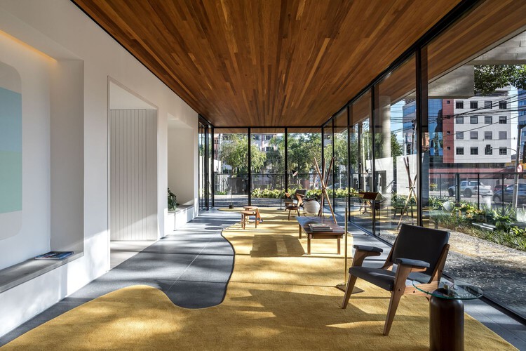 Modern strata common area with wooden ceiling and glass walls